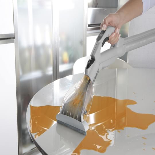Vacuuming orange color particles on counter top